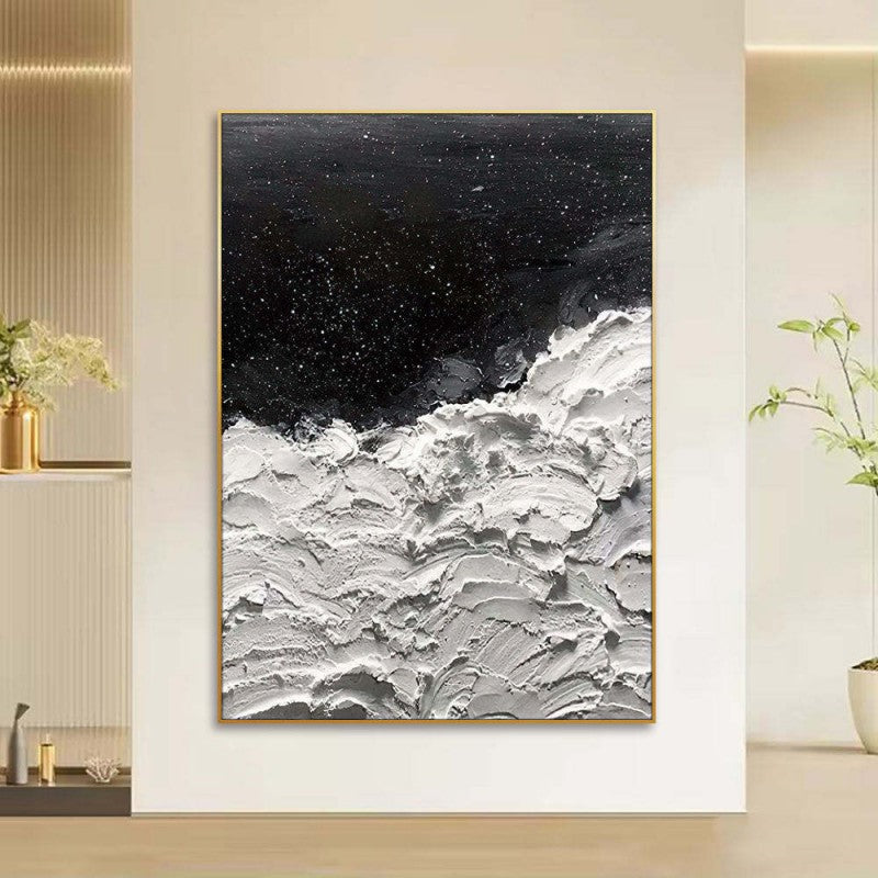 Abstract art piece with black and white colors in a modern interior setting.