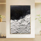 Abstract art piece with black and white colors in a modern interior setting.