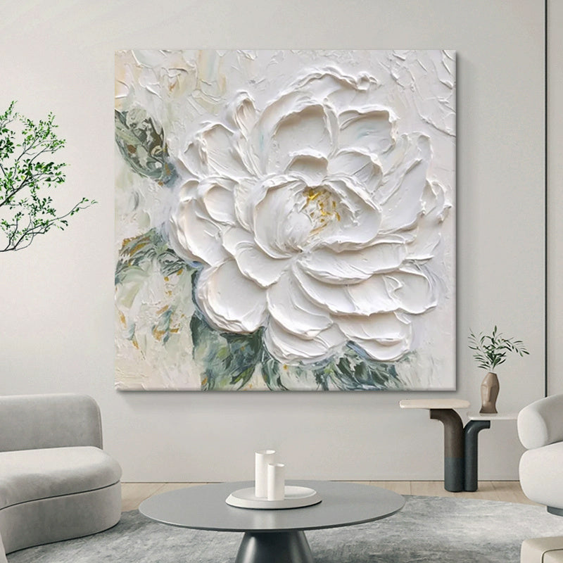 Living room with a large abstract painting of a white flower on the wall.