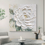 Living room with a large abstract painting of a white flower on the wall.