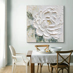 Dining room with a large floral painting on the wall above a table.