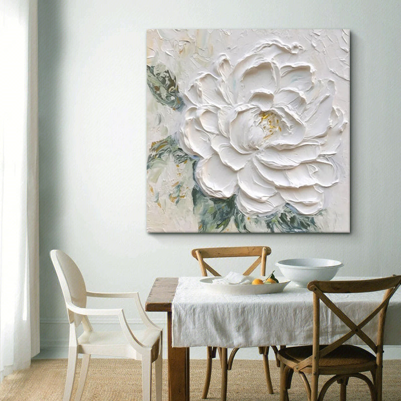 Dining room with a large floral painting on the wall above a table.