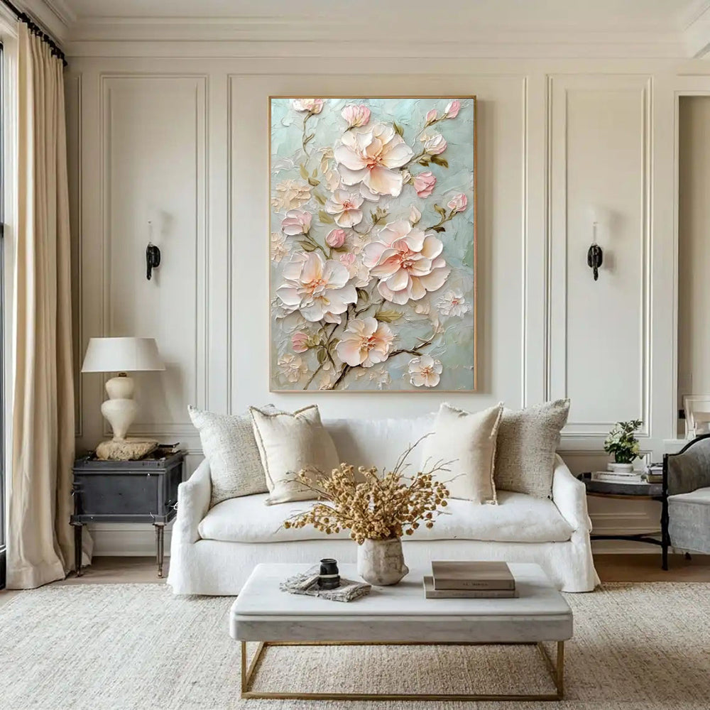 Living room with a floral painting on the wall, white sofa, and decorative elements.