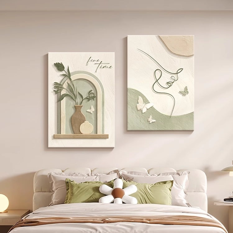 Two framed artworks on a wall above a bed with decorative pillows. Soft Harmony – Cream Line Art Wall Décor