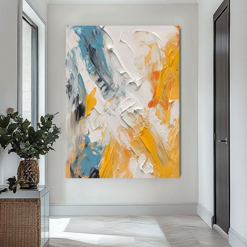 Abstract painting with yellow, blue, and white on a wall in a modern interior setting.