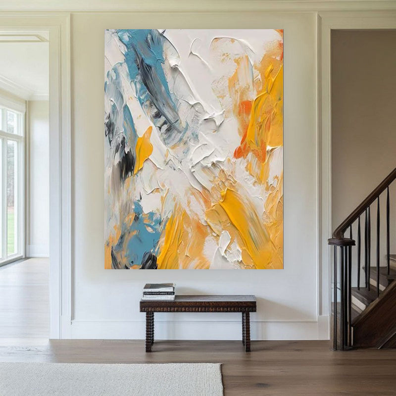 Abstract painting with blue and yellow tones in a home interior setting.