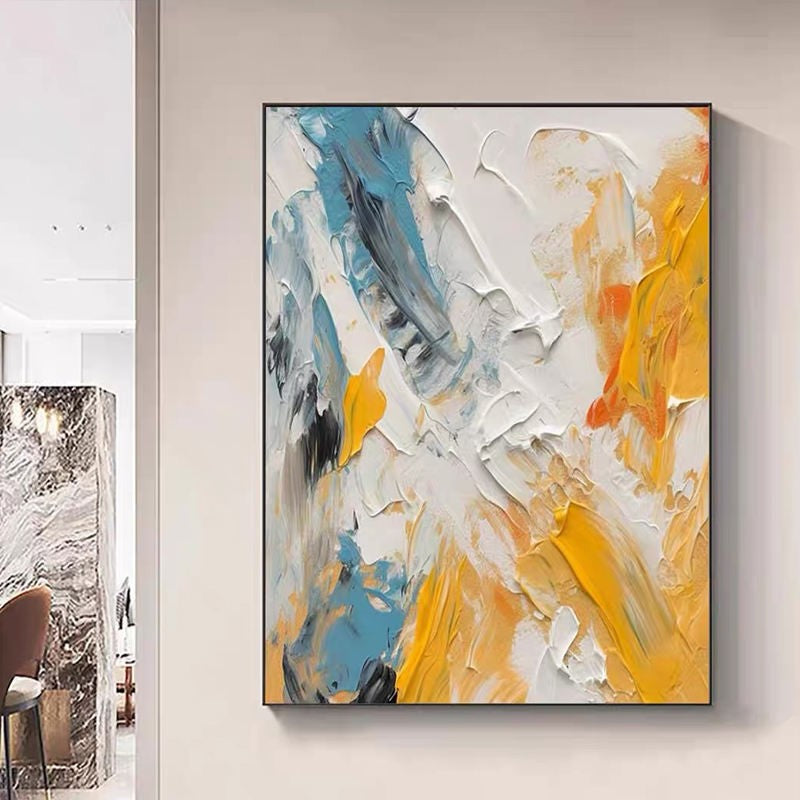 Abstract painting with blue, orange, and gray colors on a wall.