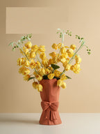 Statement ceramic flower vase with artistic bow design and neutral finish