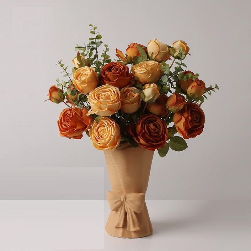 Elegant ceramic bow vase styled with delicate floral arrangement