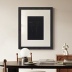 Framed abstract artwork on a wall above a dining table with decor items.