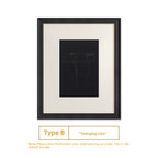 Framed artwork with a black line drawing on a white background