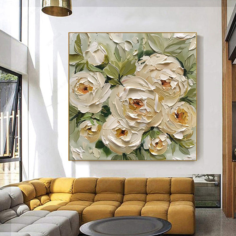 Floral painting on a wall above a yellow sofa in a living room.