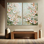 Two floral paintings on a wall above a wooden bench with decorative vases.