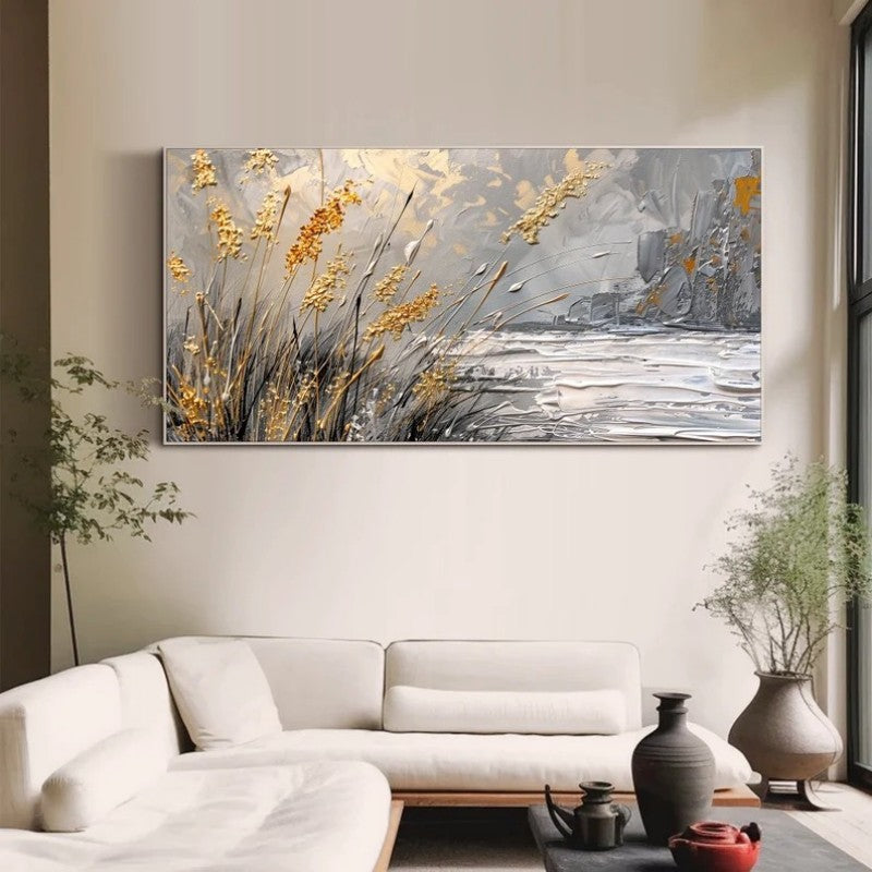 Abstract painting of a landscape with flowers on a wall above a white sofa.